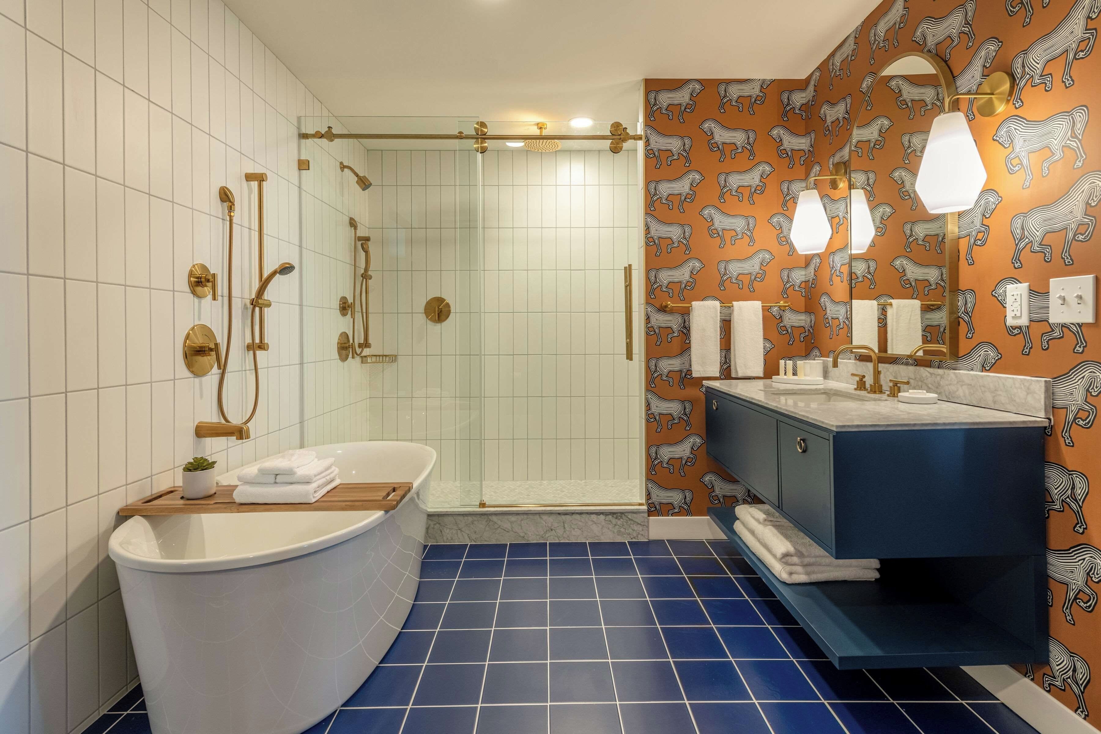 A bathroom with a freestanding bathtub, a glass-enclosed shower, and a vanity with a mirror.