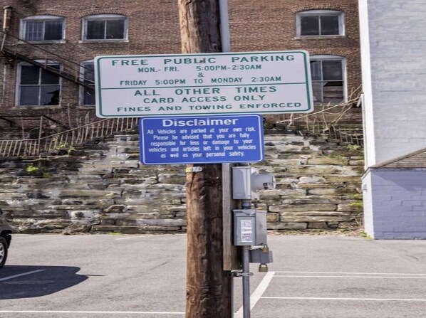 A parking sign with free public parking hours and a disclaimer.