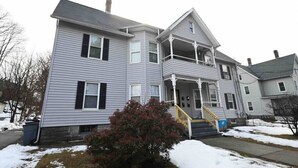A two-story house with a front porch, a staircase, and a small garden. - ENTIRE APARTMENT RECENTLY RENOVATED 2BR (Ansonia)