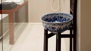 A modern bathroom with a glass shower enclosure, a white sink with a blue decorative bowl, and a wooden cabinet. - Wabi Sabi B&B - a Japanese Sleep Oasis in Belgium (Peer)
