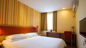 A hotel room with a bed, a desk, a chair, a TV, and a window with curtains. - Home Inn Hotel Beijing Huoying Subway Station (Beijing)