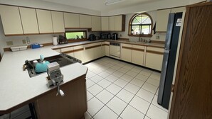 A kitchen with a central island, a built-in oven, and a window above the sink. - Beautiful Lake Front Property  (Bayview)