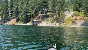 A kayak on a calm lake with a forested hillside in the background. - Beautiful Lake Front Property  (Bayview)