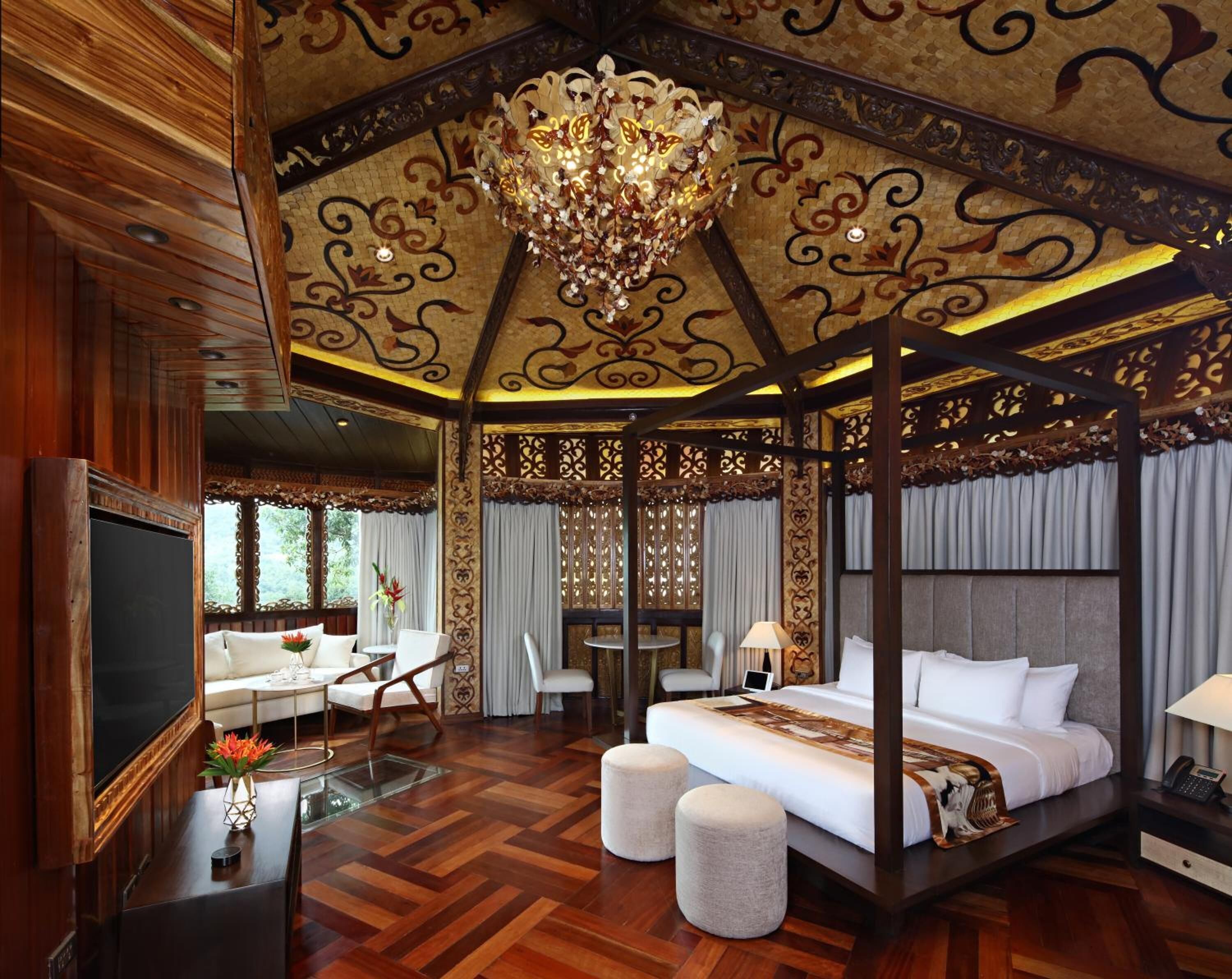A room with a four-poster bed, a chandelier, and a wooden ceiling.