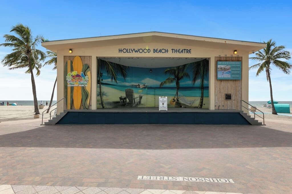 A building labeled 'Hollywood Beach Theatre' with a mural of a beach scene.