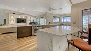 A modern kitchen with a large island, built-in appliances, and ample natural light. - NOW ACCEPTING ONE YEAR LEASES ON OUR WATERFRONT HOME! (Merritt Island)
