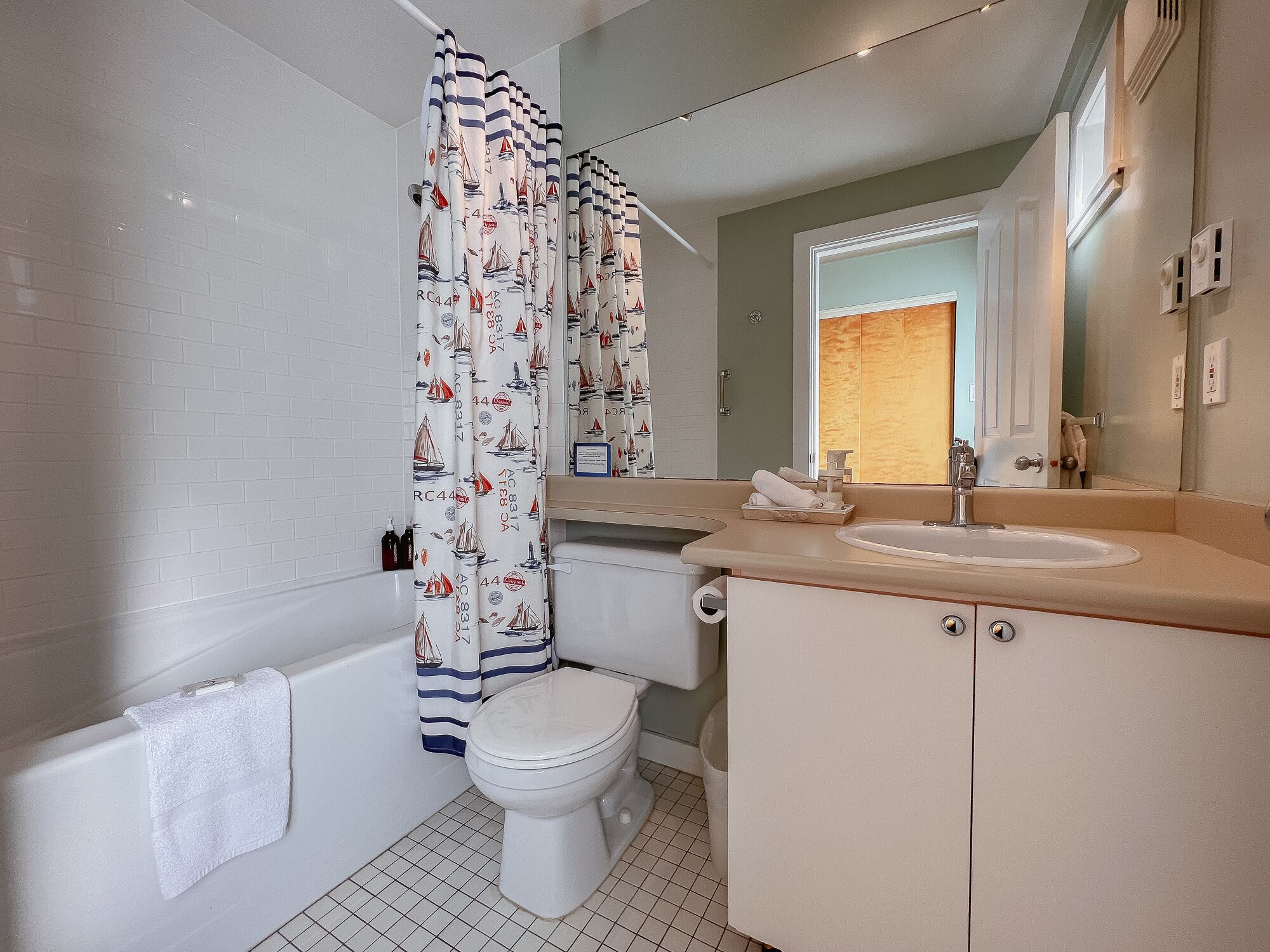 A bathroom with a toilet, sink, and bathtub.