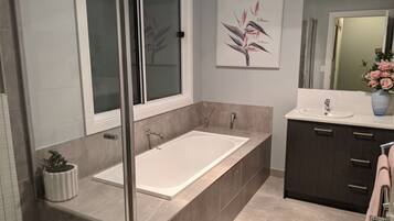 Bathtub, hair dryer, towels, soap