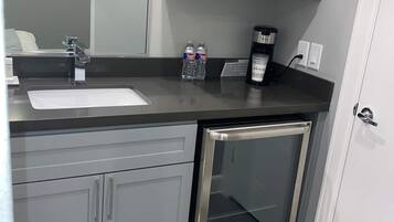 Fridge, microwave, coffee/tea maker, cookware/dishes/utensils