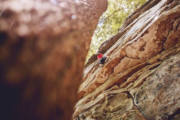 A person climbing a rocky cliff.