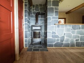 Cozy room with a fireplace and wooden ceiling beam.