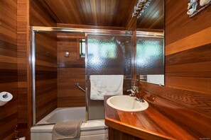 Bathtub, towels, shampoo, toilet paper