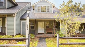 A two-story house with a front porch, a number '9342' on the door, and a small bench outside.