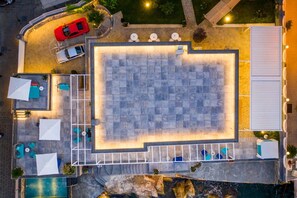 An aerial view of a hotel with a large central courtyard, outdoor seating area, and a swimming pool. - My Exclusive Italy - Beachfront Villa Sorrento & private sea access (Sorrento)