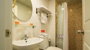 A bathroom with a sink, toilet, and shower area. - Home Inn Beijing Communication University of China West Gate (Beijing)