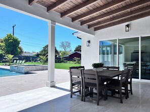 Enjoy al fresco dining on the patio, surrounded by lush greenery and a soothing waterfall feature.