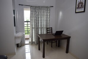 Egyptian cotton sheets, premium bedding, desk, laptop workspace - Viswa Residency by Azalea (Madurai)