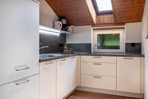 Fridge, stovetop, dishwasher, coffee/tea maker