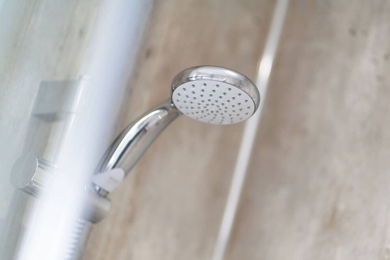 A showerhead with a circular, perforated design.