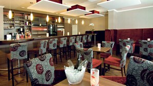 A restaurant interior with booths, a bar area, and a variety of seating options.