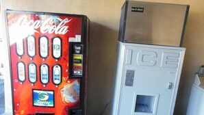 A Coca-Cola vending machine and an ice dispenser. - Americas Best Value Inn Seaside North (Seaside)