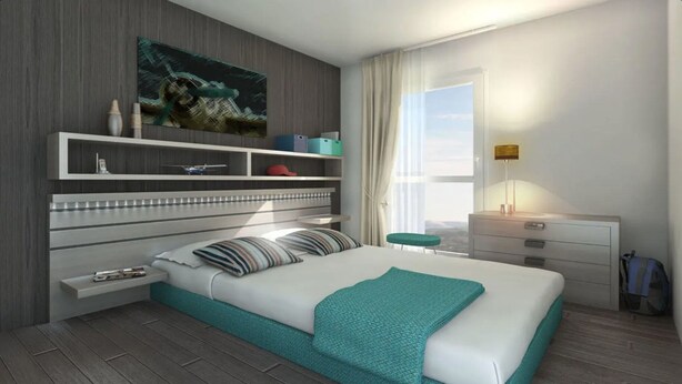 A modern hotel room with a large bed, a built-in wardrobe, a bedside table, a window with curtains, and a city view. - Les Glenans Toulouse (Toulouse)