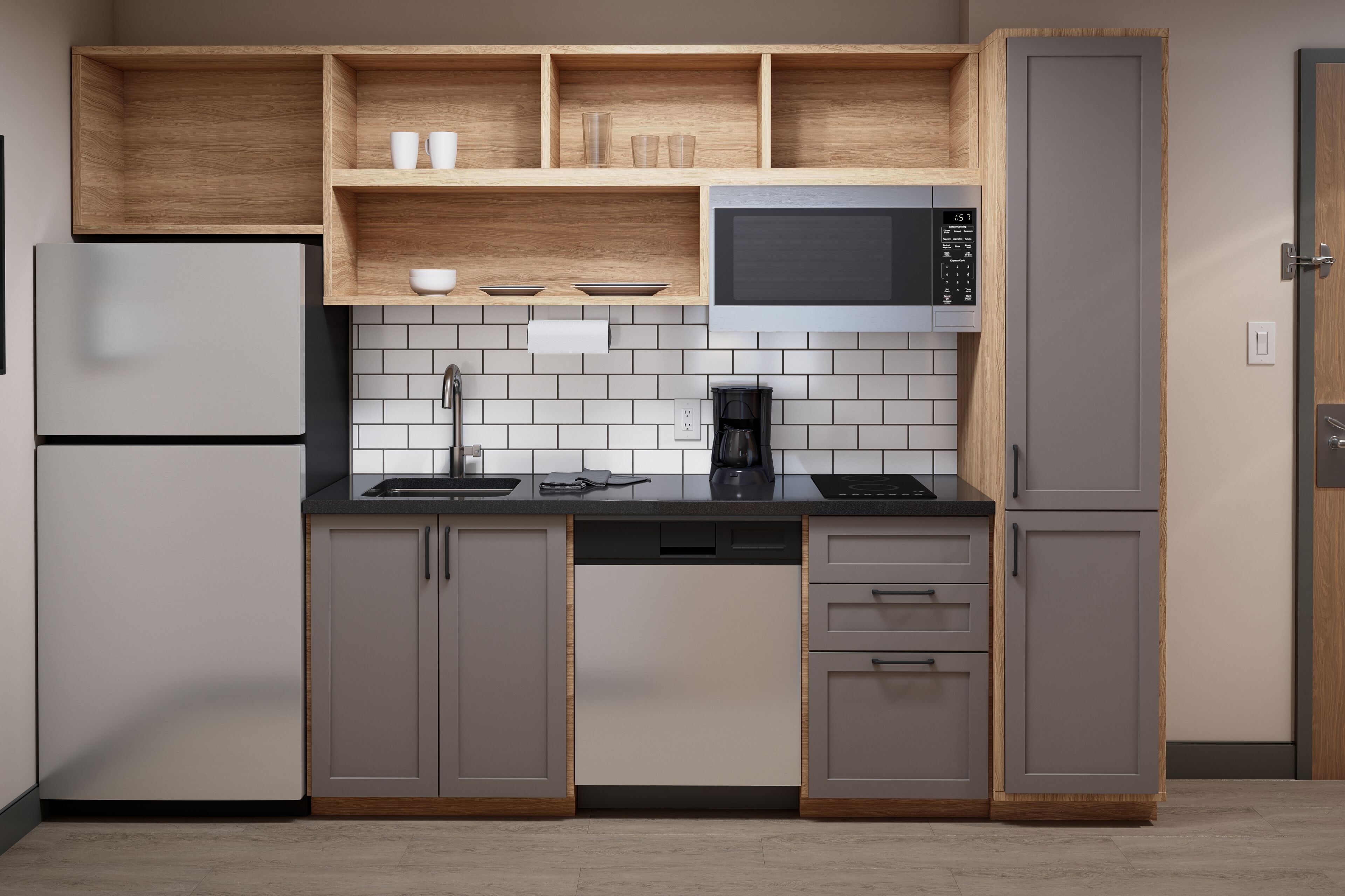 Una cocina moderna con gabinetes grises, un microondas negro y una cafetera.