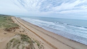 A beach with a sandy shore and waves.