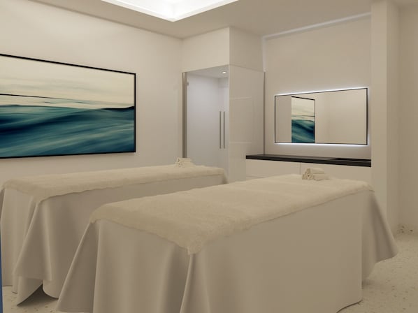 Une salle de spa moderne équipée de deux tables de massage, d’un grand tableau abstrait et d’un miroir placé au-dessus des tables.