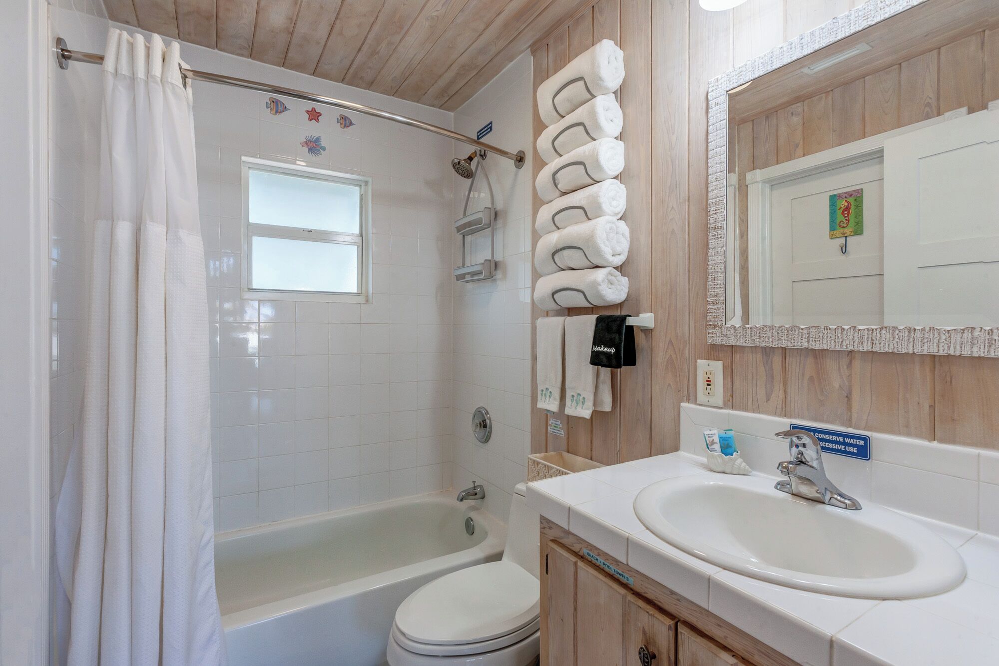 A bathroom with a shower, toilet, and sink.
