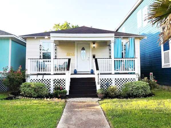 A two-story house with a front porch, a mailbox, and a number '419' on the front.