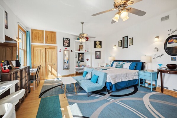 A bedroom with a bed, a desk, a chair, a wardrobe, and a ceiling fan. - Starlight Tower Suite 1 Bedroom With Stunning Views 1 Villa by RedAwning (Fort Atkinson)