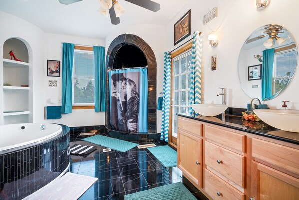 A modern bathroom with a black and white tiled floor, a freestanding bathtub, and a vanity with a mirror and sink. - Starlight Tower Suite 1 Bedroom With Stunning Views 1 Villa by RedAwning (Fort Atkinson)