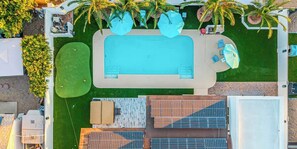 An aerial view of a pool area with a rectangular pool, sun loungers, and a covered seating area. - Private 5BR Resort | Pool, Hot Tub, En-suites (Scottsdale)
