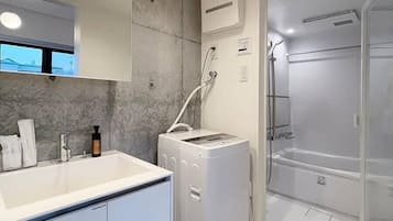 Bathtub, hair dryer, towels, soap