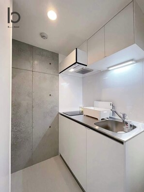 Fridge, microwave, stovetop, electric kettle - b hotel Neko Yard | Charming Studio Hideaway (Naka Ward, Hiroshima)