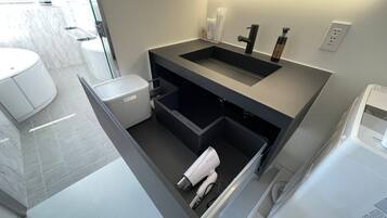 Bathtub, hair dryer, towels, soap