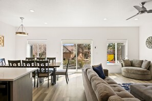 Relax and socialize in this spacious living area with a comfortable sofa and dining table.