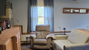 A room with a bed, a chair, a desk, and a window with curtains. - A quiet place near Ithaca, Ithaca College & Cornell. (Danby)
