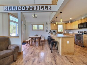 Enjoy cooking in this well-equipped kitchen with a central island, microwave, and oven.
