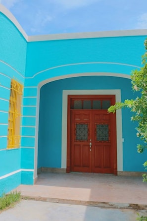 Stylish entrance with a traditional door and gate.