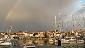 A marina with boats and buildings, including a tower. - Apartment in Banjol with Balcony, Air condition, WIFI, Dishwasher (4888-1) (Banjol)