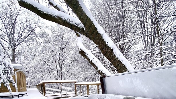 A hot tub surrounded by snow-covered trees and a wooden deck. - Escape WithInn-Relaxation Centrally Located to Beaches and Walkable Restaurants (Harbert)