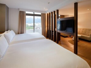 A hotel room with two beds, a TV, a sofa, and a large window with curtains. - Check Inn Select Hualien Linsen (Hualien City)