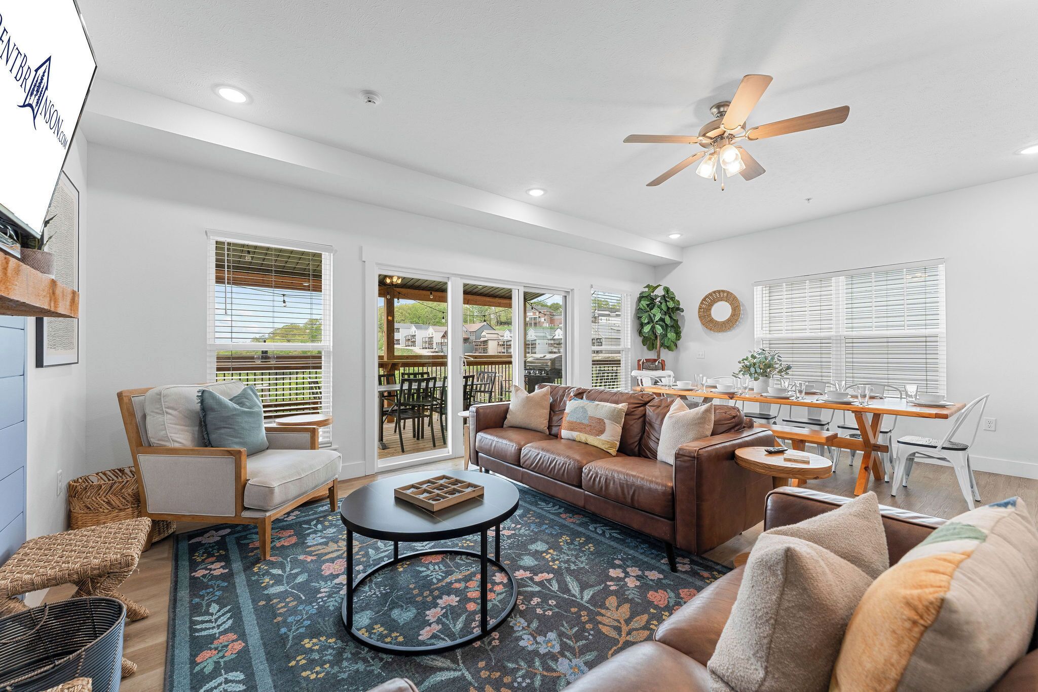 A modern living room with a sofa, coffee table, and dining area.