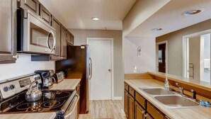 A modern kitchen with stainless steel appliances, wooden cabinets, and a double sink. - Lake Dillon! Ampitheatre, Walk to Lake,Pool&HT (Dillon)