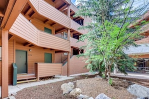 A multi-story building with a wooden facade, balconies, and a small tree in the foreground. - Lake Dillon! Ampitheatre, Walk to Lake,Pool&HT (Dillon)
