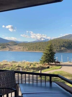 A view from a covered deck overlooking a lake, with a mountain in the background. - Lake Dillon! Ampitheatre, Walk to Lake,Pool&HT (Dillon)