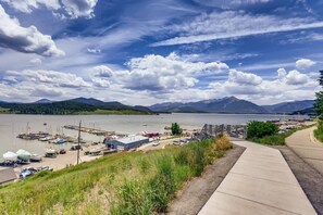 A marina with boats docked, a parking area, and a view of mountains in the background. - Lake Dillon! Ampitheatre, Walk to Lake,Pool&HT (Dillon)