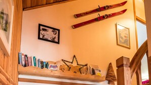 A wooden staircase with a lantern at the bottom. - "Le Bois des Neiges" Charming authentic chalet  (Xonrupt-Longemer)